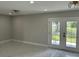Open-concept living space featuring new tile floors, with great natural lighting from the new back doors at 7021 Parliament Dr, Tampa, FL 33619