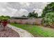 Spacious backyard with a wood privacy fence and a mulch beds with decorative rock trim at 755 Green Valley Rd, Palm Harbor, FL 34683
