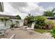Charming backyard with wood deck, decorative patio furniture, and tropical landscaping at 755 Green Valley Rd, Palm Harbor, FL 34683