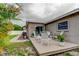 Backyard wood deck with decorative patio furniture, landscaping, and home's exterior at 755 Green Valley Rd, Palm Harbor, FL 34683