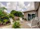 Backyard with wood deck featuring decorative patio furniture and lush tropical landscaping near the home at 755 Green Valley Rd, Palm Harbor, FL 34683