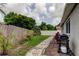 View of backyard featuring wood privacy fence, mulch beds, and sidewalk feature at 755 Green Valley Rd, Palm Harbor, FL 34683