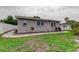 Backyard exterior view of home with mulch beds, landscaping, grass and fence at 755 Green Valley Rd, Palm Harbor, FL 34683
