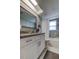 Stylish bathroom with a granite countertop vanity, mirror, and a tiled shower-tub at 755 Green Valley Rd, Palm Harbor, FL 34683