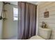 Shower with purple curtain in clean, bright, and white bathroom at 755 Green Valley Rd, Palm Harbor, FL 34683