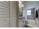 Bathroom featuring a tiled shower-tub, vanity with a granite top, and a linen closet at 755 Green Valley Rd, Palm Harbor, FL 34683