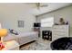 Bright bedroom featuring a bed, desk, bookshelf, and a comfortable chair at 755 Green Valley Rd, Palm Harbor, FL 34683