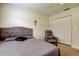 Comfortable bedroom with a upholstered headboard, closet, and a recliner at 755 Green Valley Rd, Palm Harbor, FL 34683