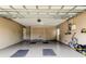 View of the spacious two car garage with painted floor, storage closets, and garage door opener at 755 Green Valley Rd, Palm Harbor, FL 34683