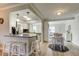 Open-concept kitchen and dining area with granite countertops, stainless steel appliances, and white cabinetry at 755 Green Valley Rd, Palm Harbor, FL 34683