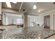 Stylish kitchen showcasing granite countertops, stainless steel appliances, and white cabinetry with open access to dining area at 755 Green Valley Rd, Palm Harbor, FL 34683