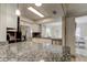 Modern kitchen with granite countertops, stainless steel appliances, white cabinetry, and lots of natural light at 755 Green Valley Rd, Palm Harbor, FL 34683