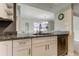 Updated kitchen with granite countertops, stainless steel dishwasher, and open view to dining area at 755 Green Valley Rd, Palm Harbor, FL 34683