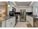 Well-equipped kitchen with stainless steel appliances, granite countertops, and white cabinets at 755 Green Valley Rd, Palm Harbor, FL 34683