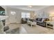 Bright living room with a fireplace, hardwood floors, neutral walls, and ample seating at 755 Green Valley Rd, Palm Harbor, FL 34683