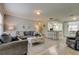 Comfortable living room featuring hardwood floors, neutral walls, and an open layout to the dining and kitchen area at 755 Green Valley Rd, Palm Harbor, FL 34683