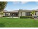 Backyard with green grass, patio furniture, a well maintained lawn, and mature landscaping at 808 Vittorio Pl, Brandon, FL 33511