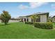 View of the backyard featuring a green lawn, garden hedging, a patio and perimeter fencing at 808 Vittorio Pl, Brandon, FL 33511