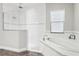 Bright bathroom featuring a frameless shower, soaking tub, and white tile at 808 Vittorio Pl, Brandon, FL 33511