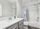 Well-lit bathroom with a single vanity and tub shower combo with blue patterned shower curtain at 808 Vittorio Pl, Brandon, FL 33511