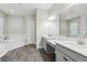 Bright bathroom features a soaking tub, dual sink vanity, and wood-look tile flooring at 808 Vittorio Pl, Brandon, FL 33511