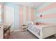 Colorful bedroom with striped walls, white furnishings, and soft carpet at 808 Vittorio Pl, Brandon, FL 33511