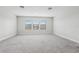 Large bonus room with plush carpeting and natural light from three windows at 808 Vittorio Pl, Brandon, FL 33511