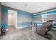 Versatile bonus room with accent wall, wood-look floors, and natural light at 808 Vittorio Pl, Brandon, FL 33511