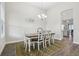 Cozy dining room with stylish table and chairs with a view into the kitchen at 808 Vittorio Pl, Brandon, FL 33511