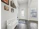 Inviting entryway with decorative door, wood-look tile flooring, bench seating, and tasteful wall decor at 808 Vittorio Pl, Brandon, FL 33511