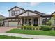 Charming two-story home with a well-manicured lawn, brick driveway, and welcoming front porch with decorative columns at 808 Vittorio Pl, Brandon, FL 33511
