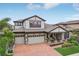 Beautiful two-story home with a three-car garage, manicured lawn, and charming front porch at 808 Vittorio Pl, Brandon, FL 33511