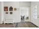 Inviting foyer with front door, a bench, and access to an office at 808 Vittorio Pl, Brandon, FL 33511