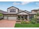Charming two-story home with a front porch, a brick driveway, a two car garage, and curb appeal at 808 Vittorio Pl, Brandon, FL 33511