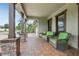 Inviting front porch featuring comfortable seating, brick flooring, and decorative columns offering a cozy outdoor space at 808 Vittorio Pl, Brandon, FL 33511