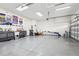 Spacious three car garage with epoxy flooring, overhead lighting, and ample storage and organization at 808 Vittorio Pl, Brandon, FL 33511