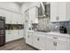 Modern kitchen with white cabinetry, stainless steel appliances, stylish backsplash, and beautiful countertops at 808 Vittorio Pl, Brandon, FL 33511