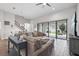Bright living room with a large sectional sofa, sliding glass doors to the patio, and stairs to the second floor at 808 Vittorio Pl, Brandon, FL 33511