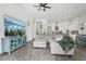 Comfortable living room with stylish decor, wood-look tile flooring, and an open layout connecting to the kitchen at 808 Vittorio Pl, Brandon, FL 33511
