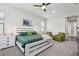 Serene main bedroom with a white wooden bed frame and green accents, and cozy sitting area at 808 Vittorio Pl, Brandon, FL 33511