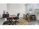 Bright office with two wooden desks, ergonomic chairs, a decorative rug, and natural light from the window at 808 Vittorio Pl, Brandon, FL 33511