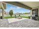 An outdoor seating area with stone pavers, a fire pit, a grill and comfortable seating at 808 Vittorio Pl, Brandon, FL 33511