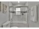 Updated bathroom featuring tiled shower/tub combo with glass doors and modern fixtures at 8222 Valrie Ln, Riverview, FL 33569