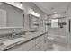 Bathroom features a double sink vanity with granite countertop and a tiled shower/tub at 8222 Valrie Ln, Riverview, FL 33569