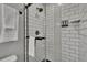 Bathroom features glass shower with black fixtures and white subway tiled walls at 8222 Valrie Ln, Riverview, FL 33569