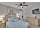 Bedroom with a bed, ceiling fan, dresser, and ensuite bathroom at 8222 Valrie Ln, Riverview, FL 33569