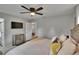Relaxing bedroom features a queen sized bed, mounted TV, and a decorative bureau for ample storage at 8222 Valrie Ln, Riverview, FL 33569