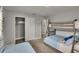 Bright bedroom featuring carpet floors, closet, and a bunk bed with blue bedding perfect for a room at 8222 Valrie Ln, Riverview, FL 33569