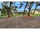 Beautiful home with mature trees, manicured lawn, and red mulch beds creating lovely curb appeal at 8222 Valrie Ln, Riverview, FL 33569