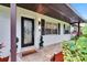 Beautiful front entrance with decorative door, potted plants, and well-maintained brick and shutters at 8222 Valrie Ln, Riverview, FL 33569